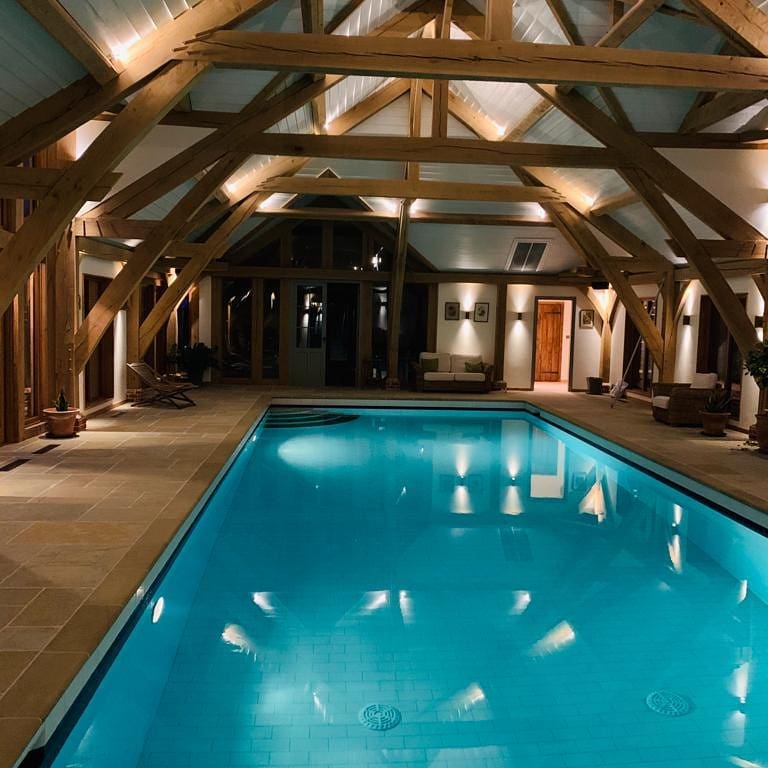 Discreet architectural lighting integrated into a luxury pool and living area